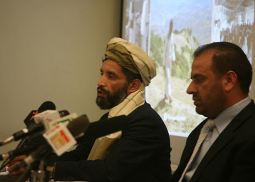 AGimage3 Senior Program Officers Fazel Rabi Haqbeen (left) and Fazel Rabi Wardak (right). In the background is a poster that shows a field researcher walking between survey points in the mountains of Badakhshan province.