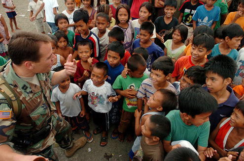 A U.S. army captain greets children in the Philippines