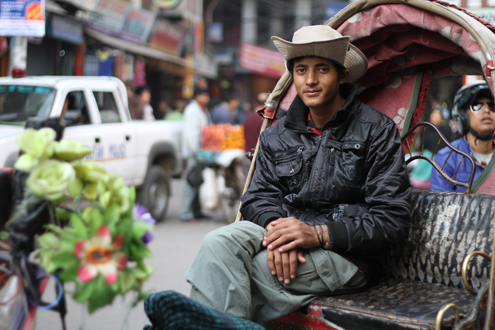 Man waits in his rickshaw for a customer. Man waits in his rickshaw for a customer.