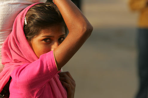 YoungIndianGirl A young Indian girl carries a sack.