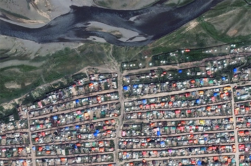 Satellite imagery from the Khan-Uul district shows a dense neighborhood butting up against the Tuul River. © 2014 DigitalGlobe / Mapbox