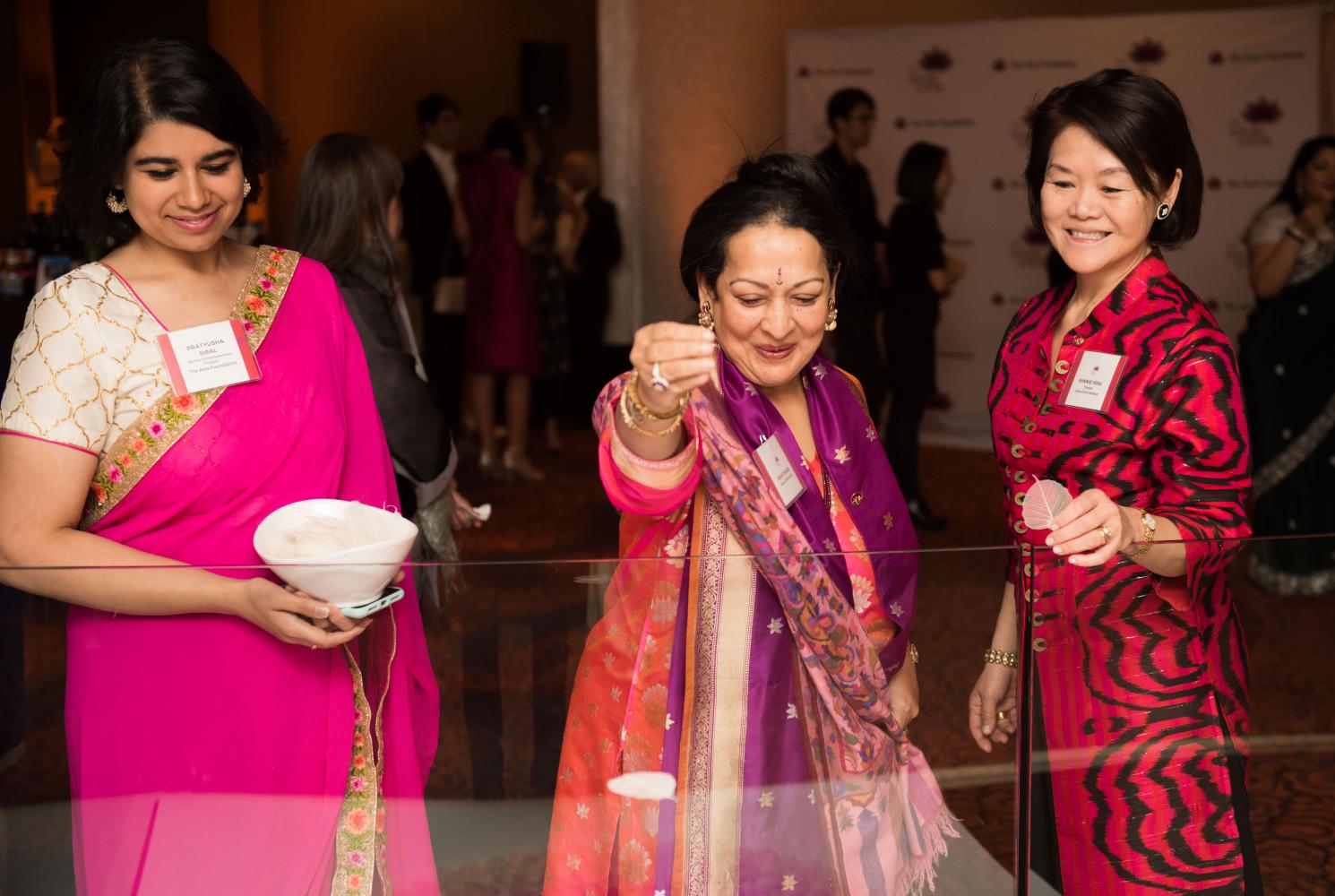 Pratyusha Sibal and Lotus Advisors Swati Bhisé and Winnie Feng hold Lotus leaves