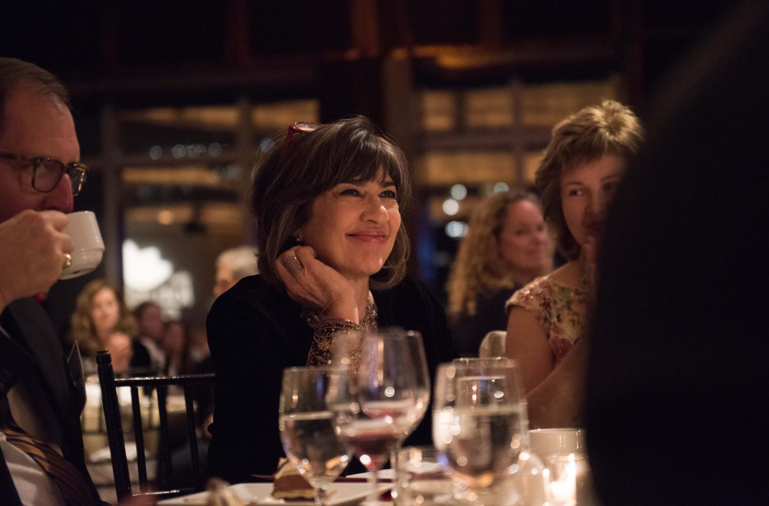 Award-winning journalist and honoree Christiane Amanpour smiles while looking at crowd