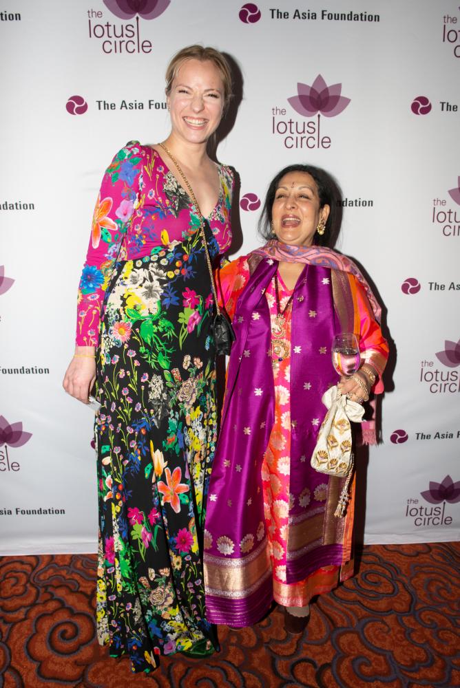 Patron and Swati Bhisé smile for photo against Lotus awards backdrop