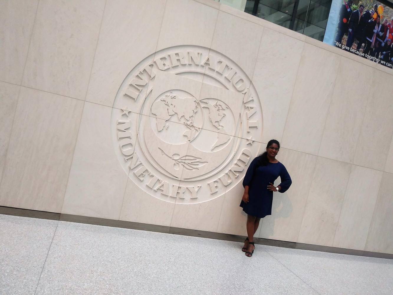 Development Fellow Hansani Chapa Perera in front of the International Monetary Fund emblem