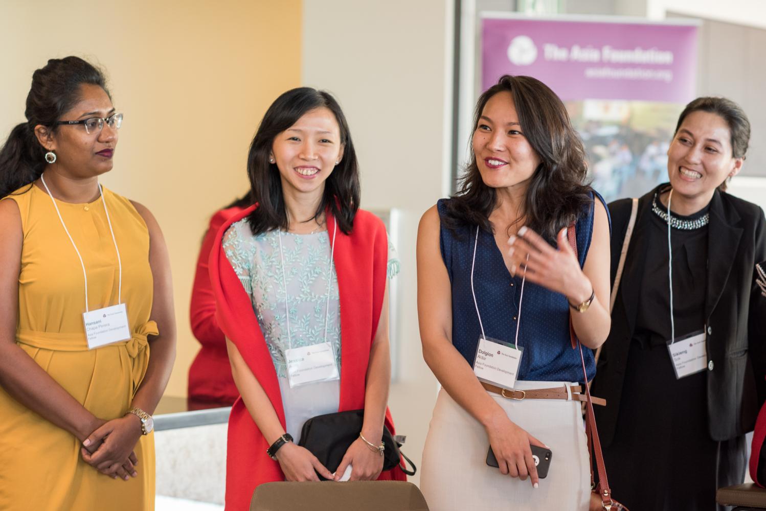 Four female Development Fellows engage in conversation while attending McKinsey & Company reception
