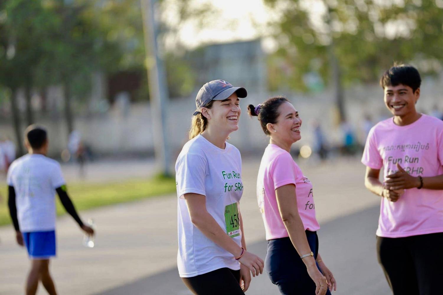 Two women and a man smile during a fundraiser run