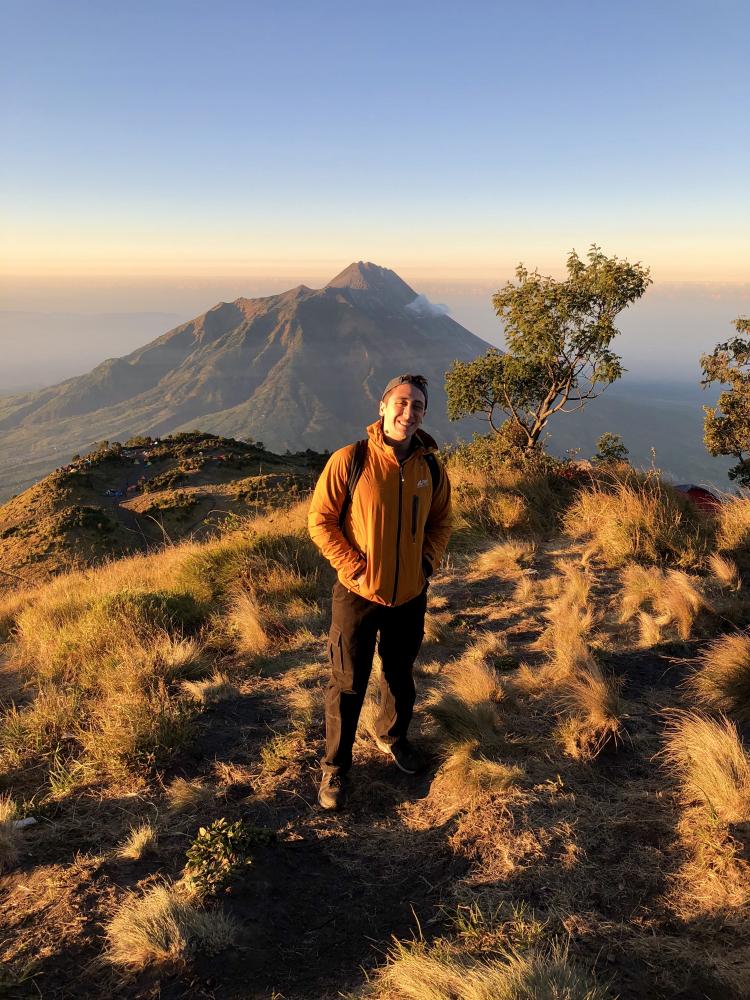 A man stands on mountaintop in Indonesia