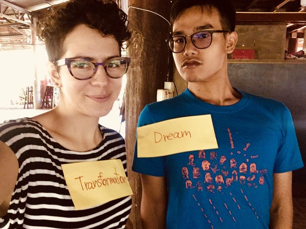 A man wearing name tag that says "dream" and woman wearing a name tag that says "transformation"