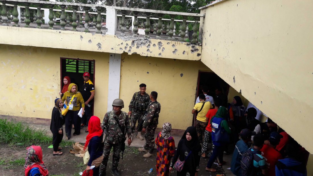 At the bullet-scarred municipal hall of Butig, where the extremists and the military had an encounter in mid-February, tensions remain due to heavily armed security forces manning the precinct. Photo by Anna Tasnim Basman 