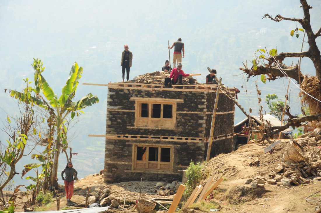 Reconstruction of a house in Nele VDC. Most of the earthquake-affected districts lie in the hilly and mountain regions with very poor to no road networks. 