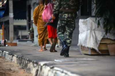 Buddhist monk and soldiers feet Pattani town