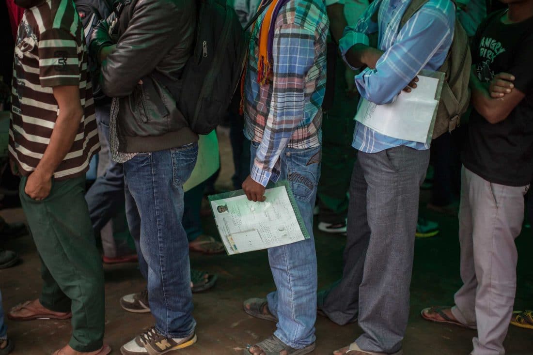 Migrant workers wait in line to apply for Nepali passports before the pandemic