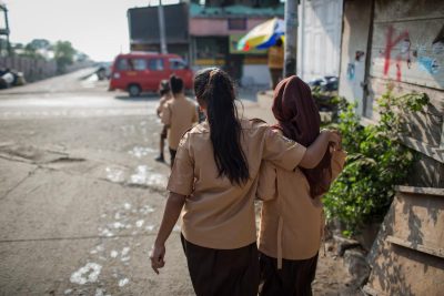 Two girls walk to school in North Jakarta.