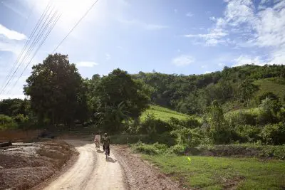 two people bike along a dirt path