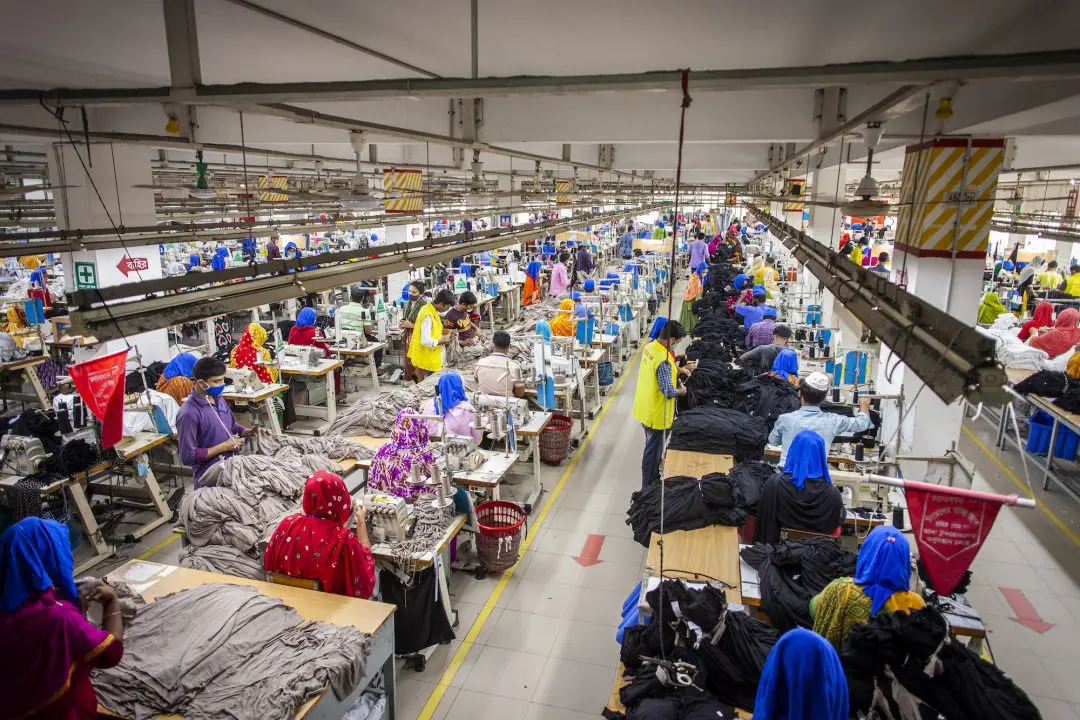 Rows of employees work alongside another at an export-oriented apparel factory in Sreepur