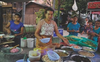 Woman serves dish in street market