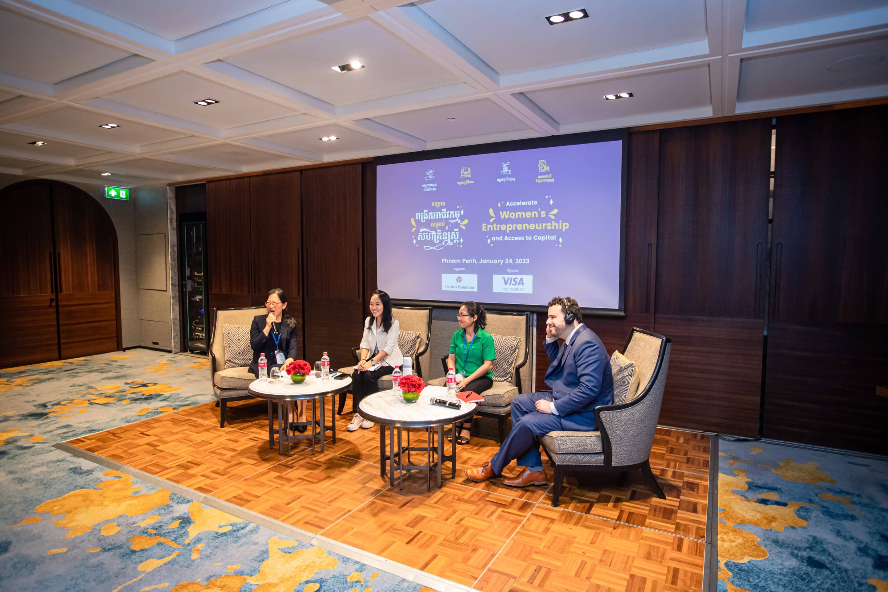 Speakers sit on stage at workshop