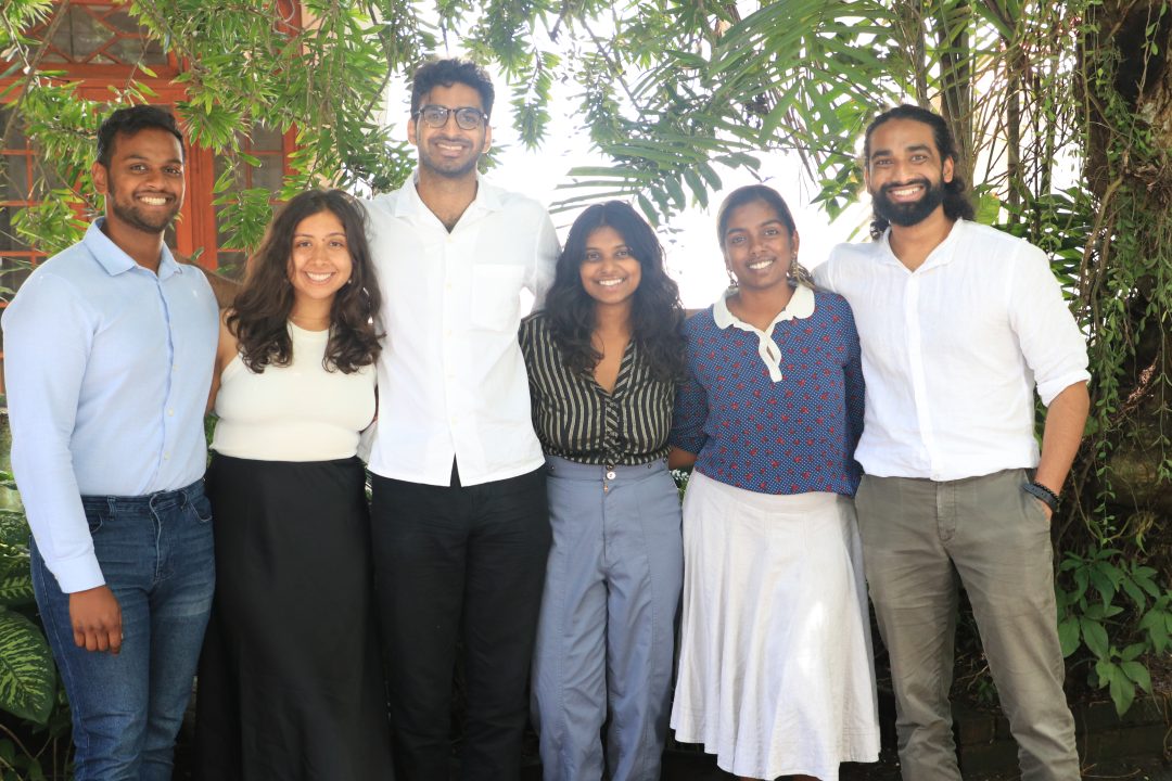 Six young people of Sri Lankan descent smile for the camera
