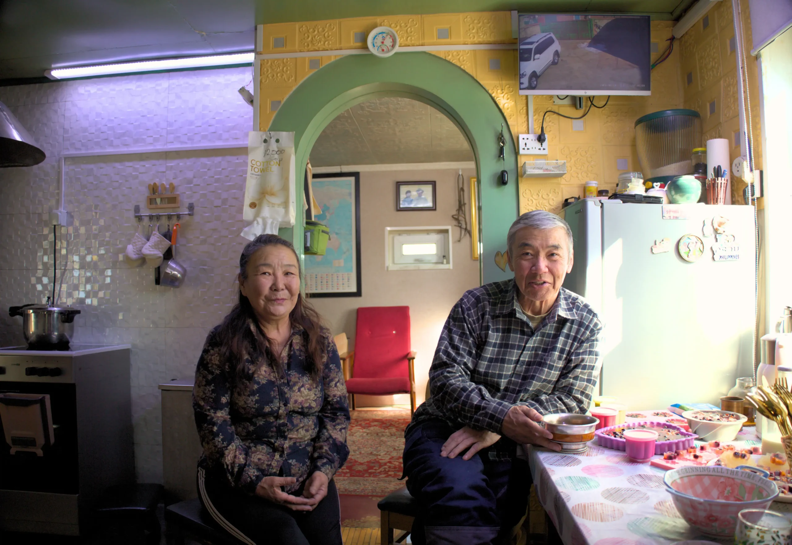 From left: Ms.Davaakhuu, and Mr.Namsraidorj in their living room, Ulaanbaatar Mongolia 2026