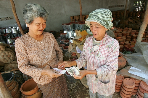 Kai Savat is a wholesaler who supplies ox cart vendors with pottery to sell around Cambodia. Photo by Karl Grobl.
