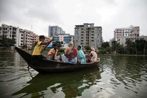 A family crosses the river in Dhaka
