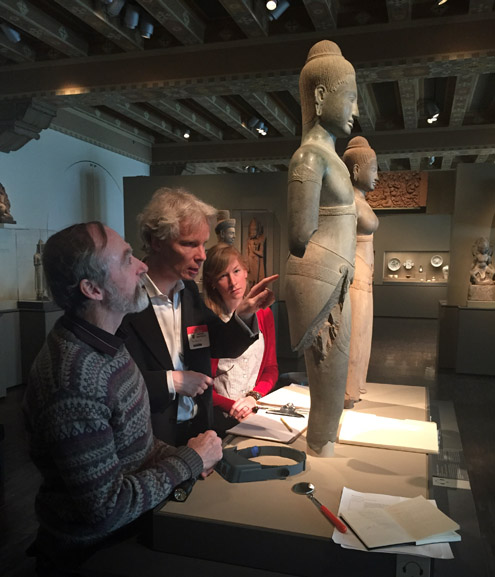 Pierre Baptiste (center) examines statues of Shiva and Parvati at the Asian Art Museum in San Francisco. Photo courtesy Asian Art Museum