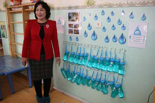 Principal Mijiddorj shows us the reusable BPA-free bottles that are now available to students at her school. 